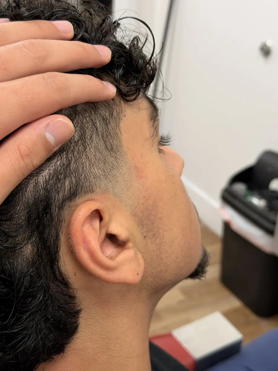 Close view of a tapered haircut near the temple