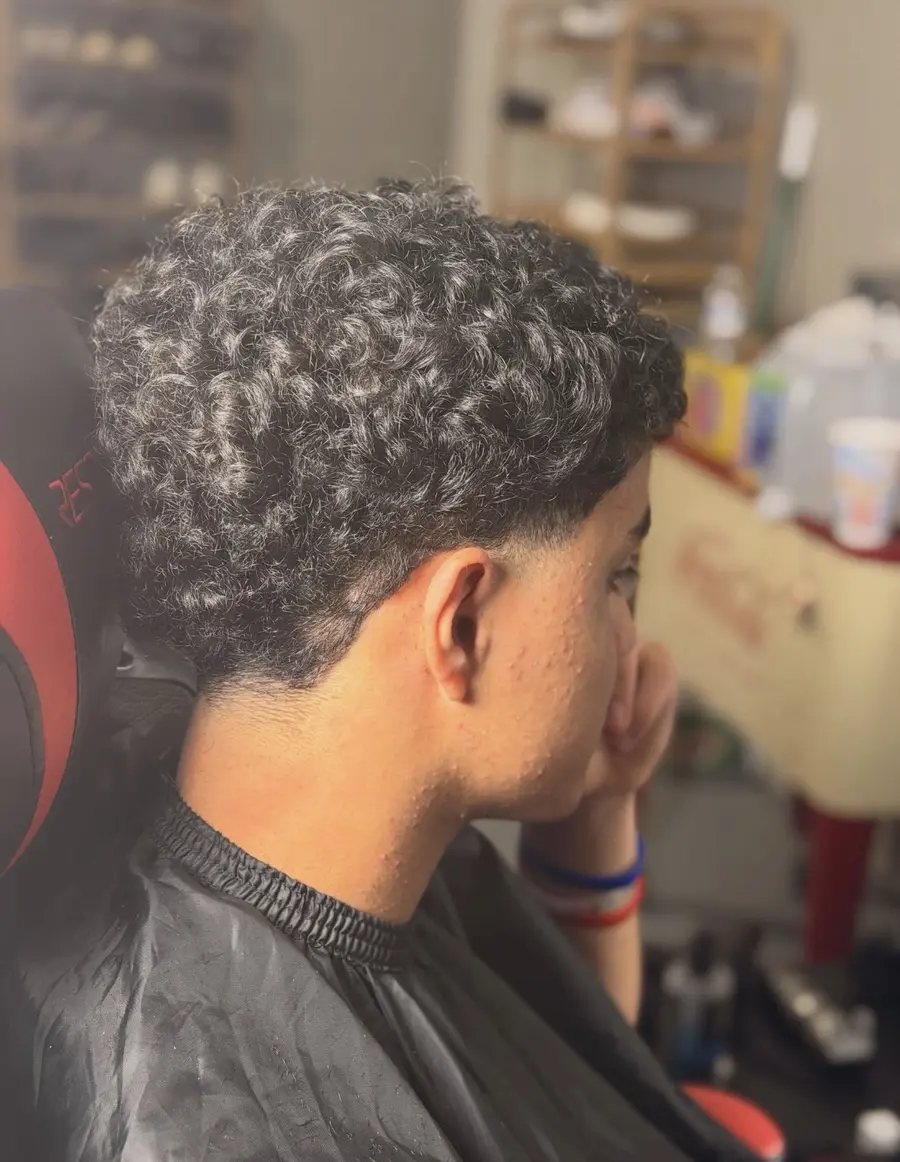 Side profile showing a shaped haircut in the barber chair